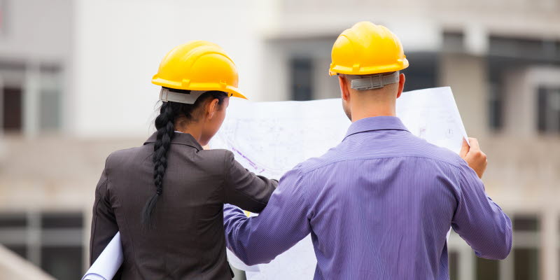 Construction manager and engineer woman working on a building site