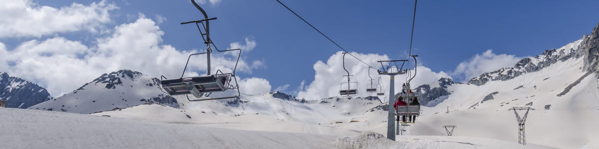 Cable car for skiers in the mountains of Northern Italy Alps on a clear sunny day