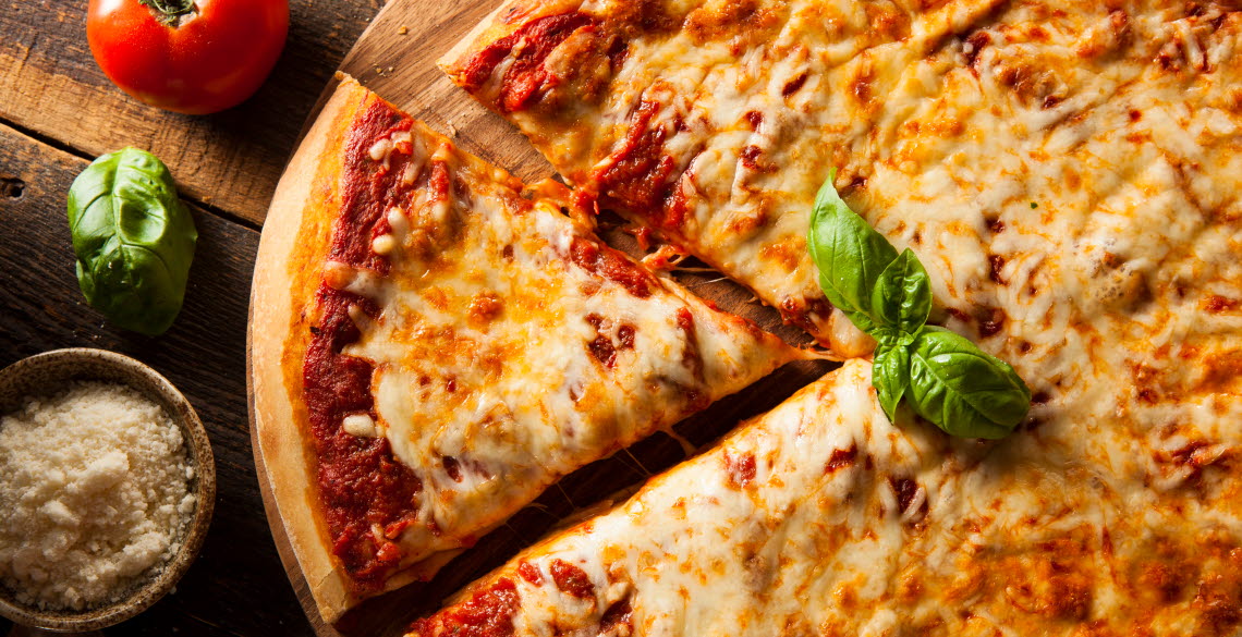 Cheese and tomato pizza on wooden plate.