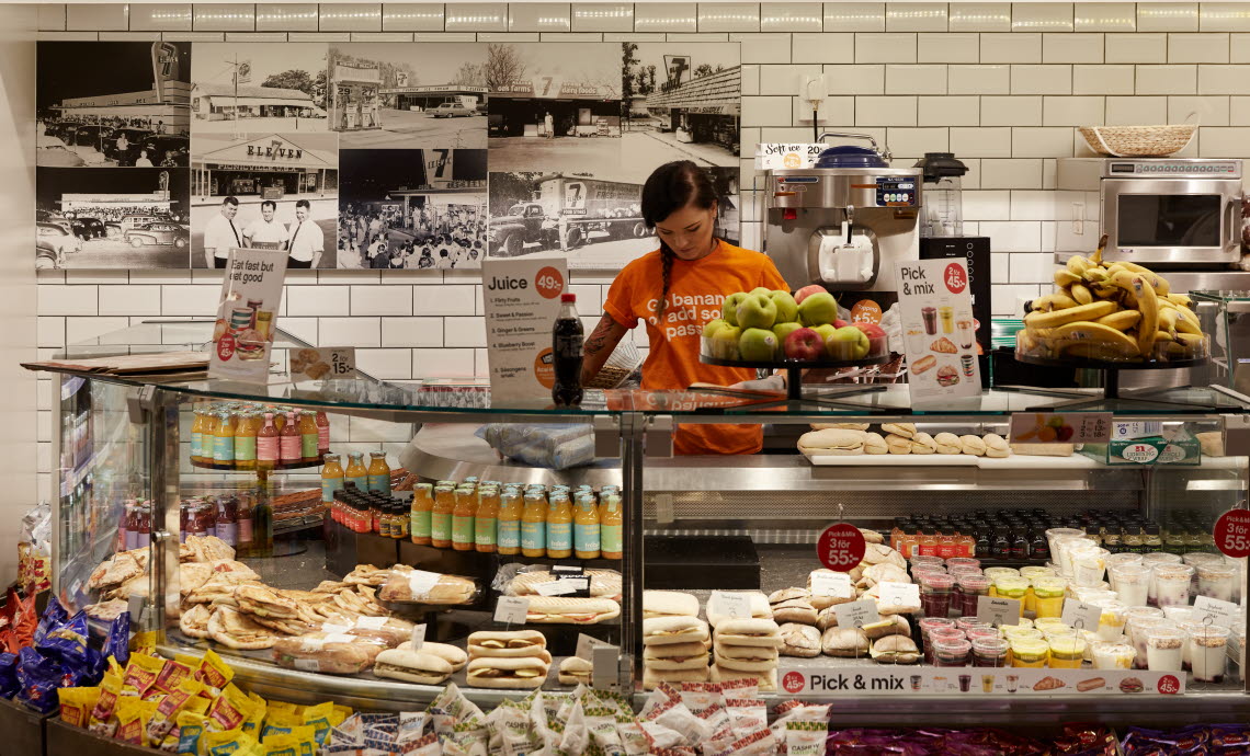 7-Eleven counter with food and a clerk behind