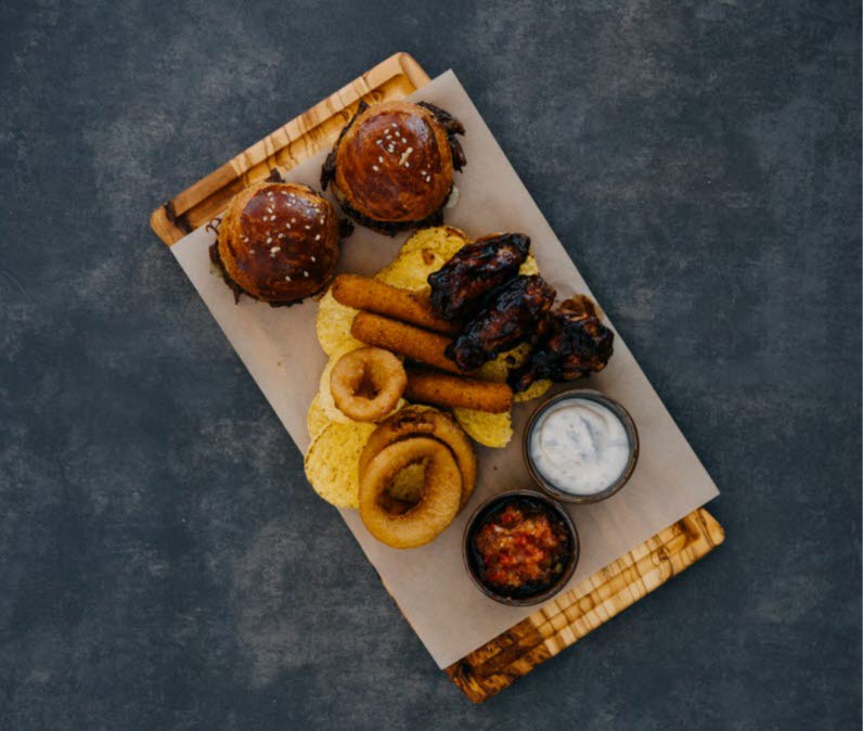 Platter with meats, buns, nachos and dip