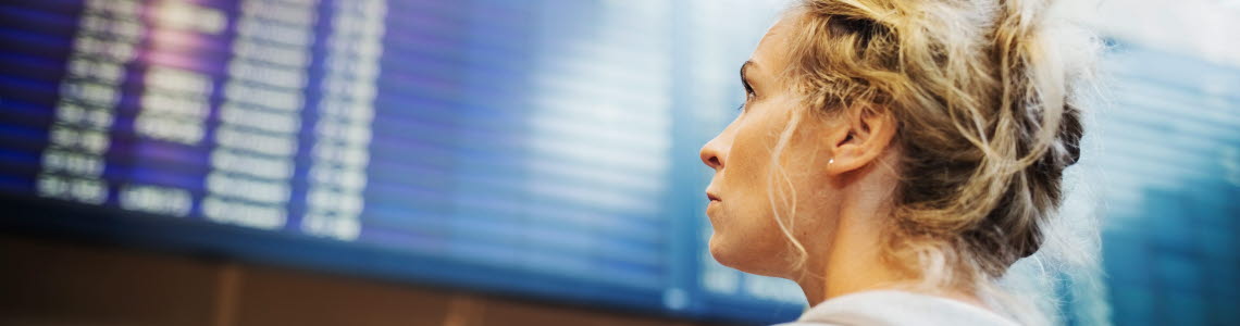 A person looking at board with arrivals or departures at Arlanda