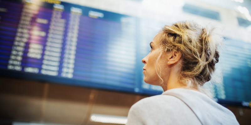 A person looking at board with arrivals or departures at Arlanda