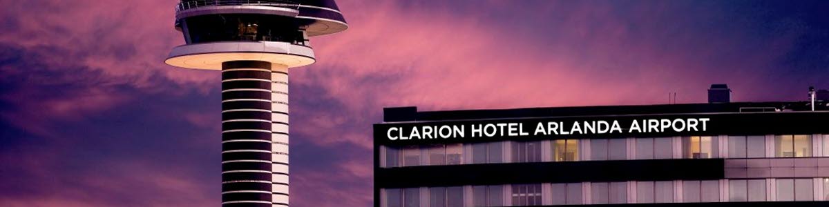 View of the control tower and Clarion hotels in pink shimmering sky