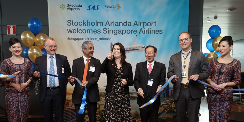 People holding and cutting a ribbon