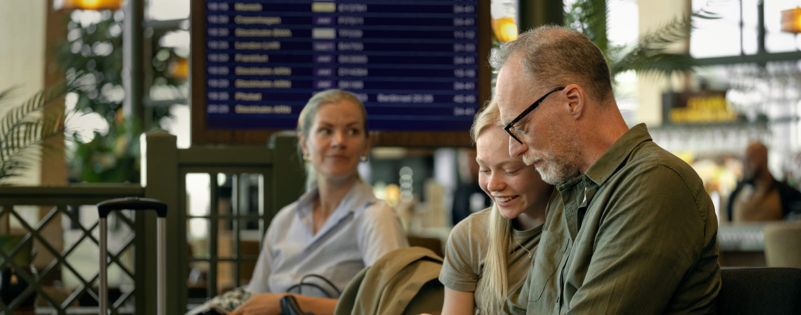 Smiling travelers in an airport waiting area