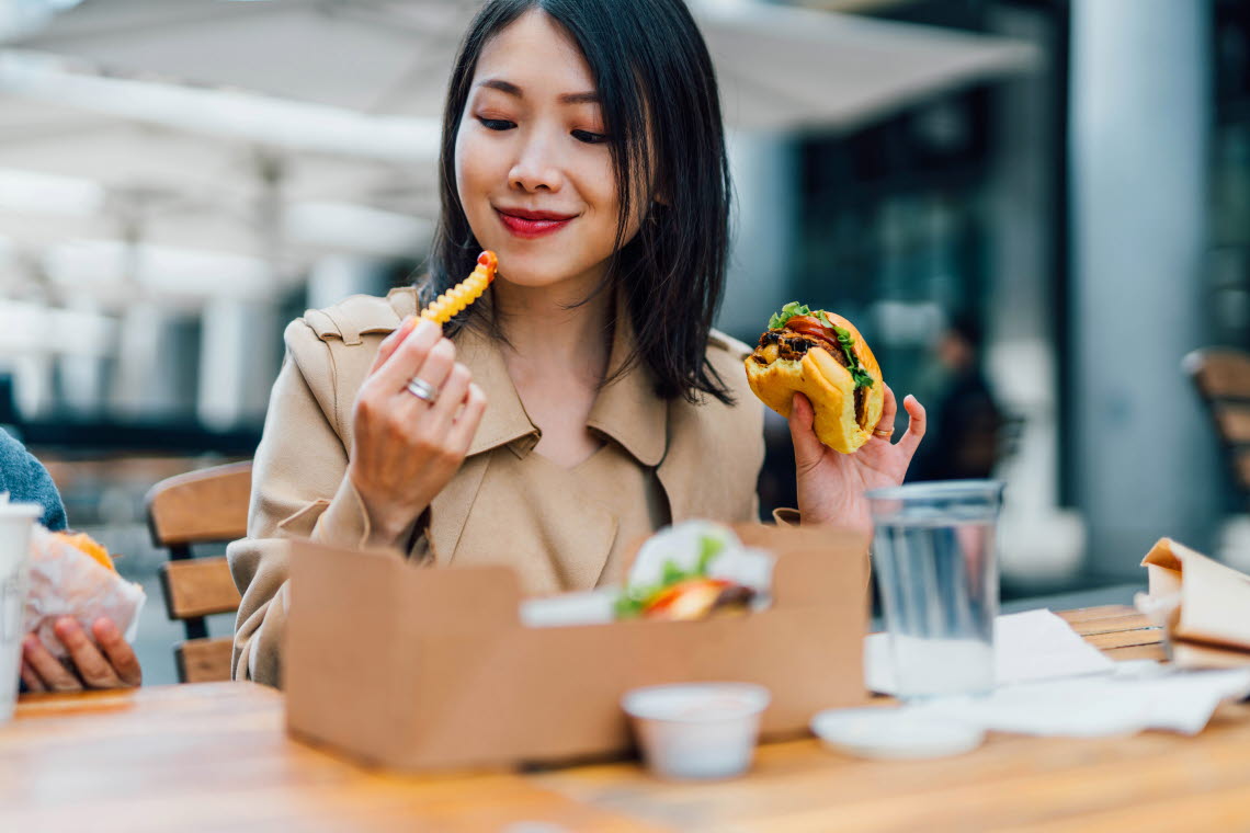 Woman eating burger and fries