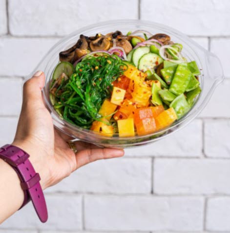 Hand holding salad bowl