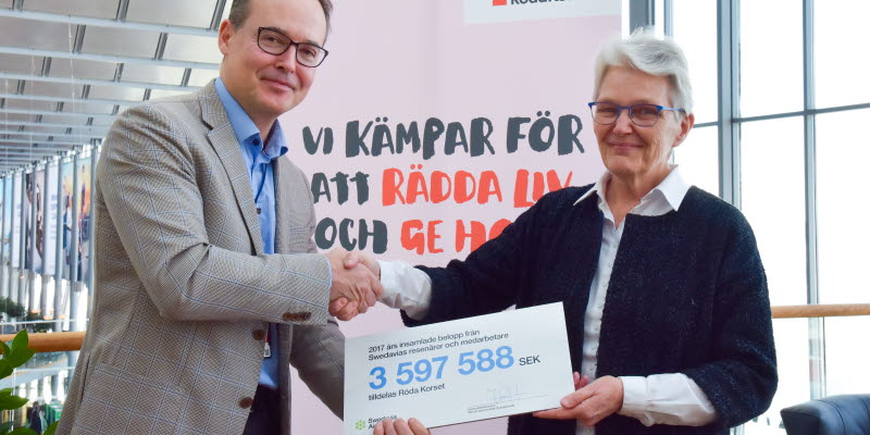 Swedavias vd Jonas Abrahamsson överlämnar checken på 3,6 miljoner kronor till Svenska Röda Korsets ordförande Margareta Wahlström. 