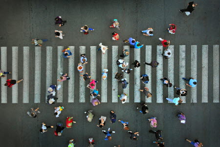 People in motion walking across a pedestrian crossing