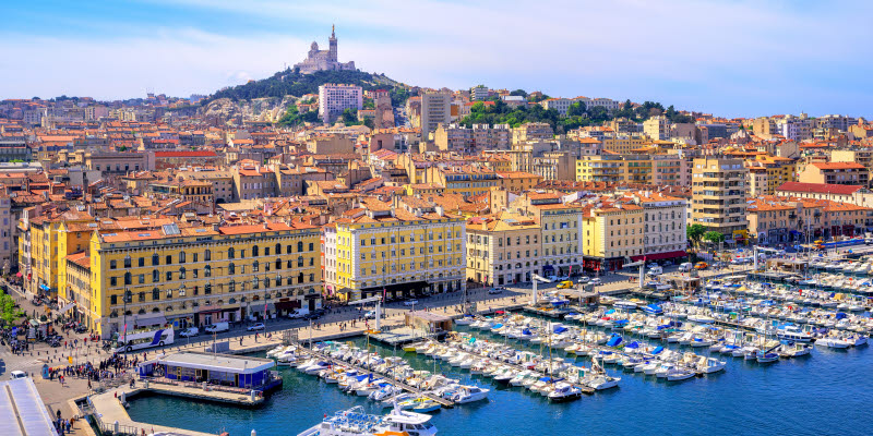 The old Vieux Port and Basilica Notre Dame de la Garde in the historical city center of Marseilles, France