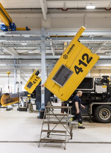 A yellow bus being repared